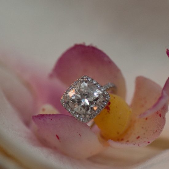 Cushion diamond engagement ring with diamond halo